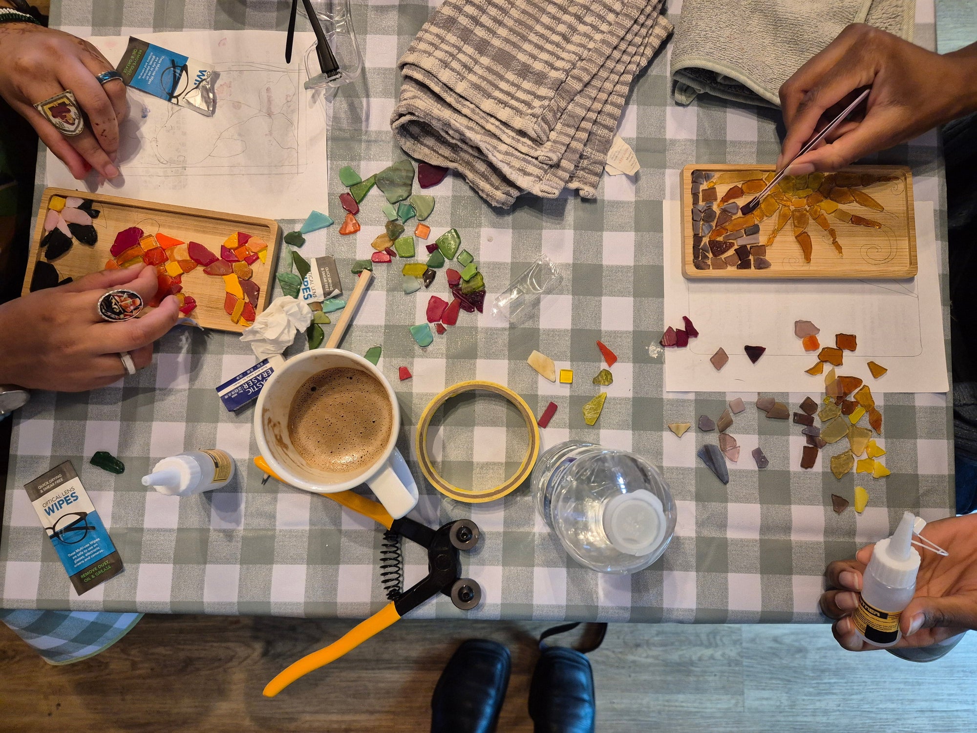 Artistic activity with small tools and materials on a checkered tablecloth